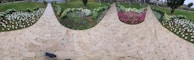 Neatly raked garden pathway bordered by colorful flowers.