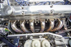Close-up of shiny automotive electrical parts arranged neatly on a black surface