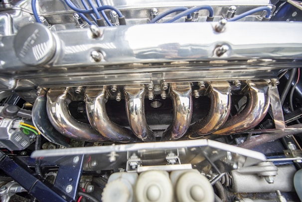 Close-up of a shiny engine block with polished metal surfaces reflecting light.