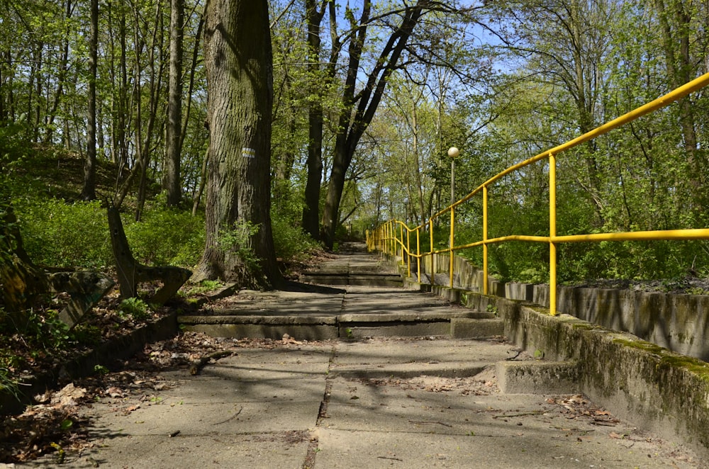 a yellow railing is on the side of a road