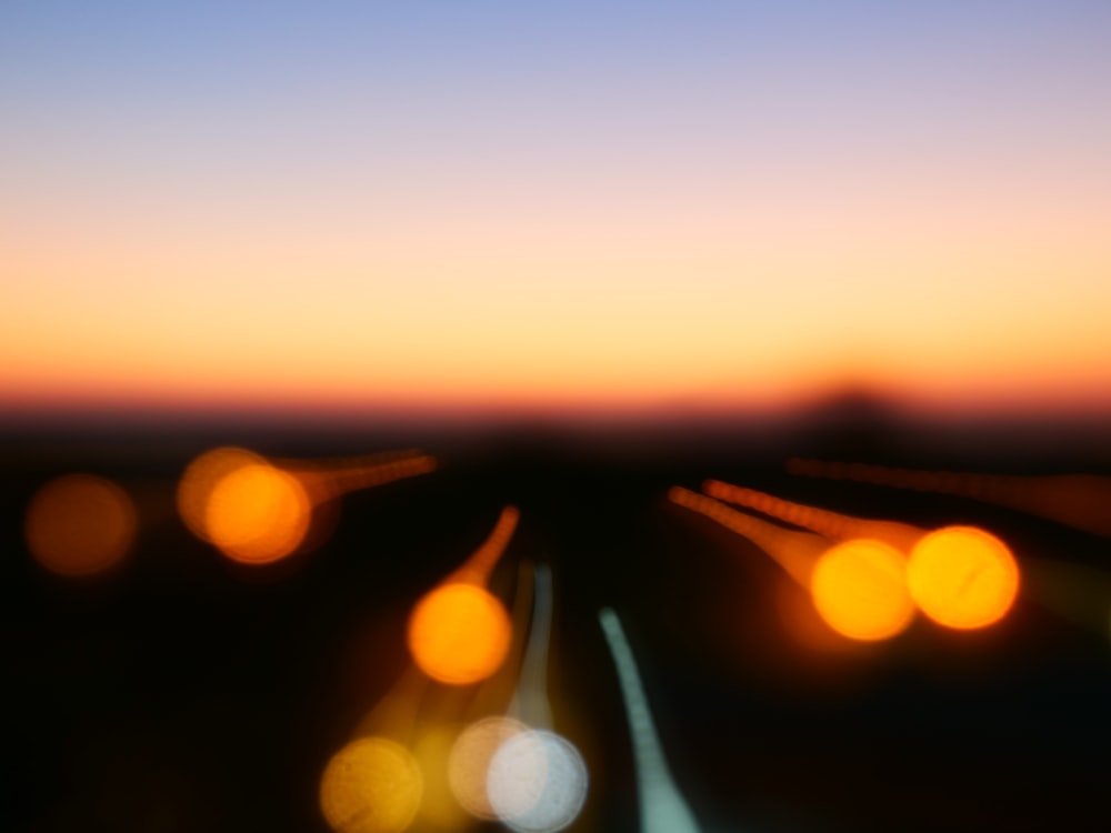 a blurry photo of a train track at sunset
