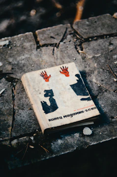 A black-and-white book cover with deep red ink spreading like veins.