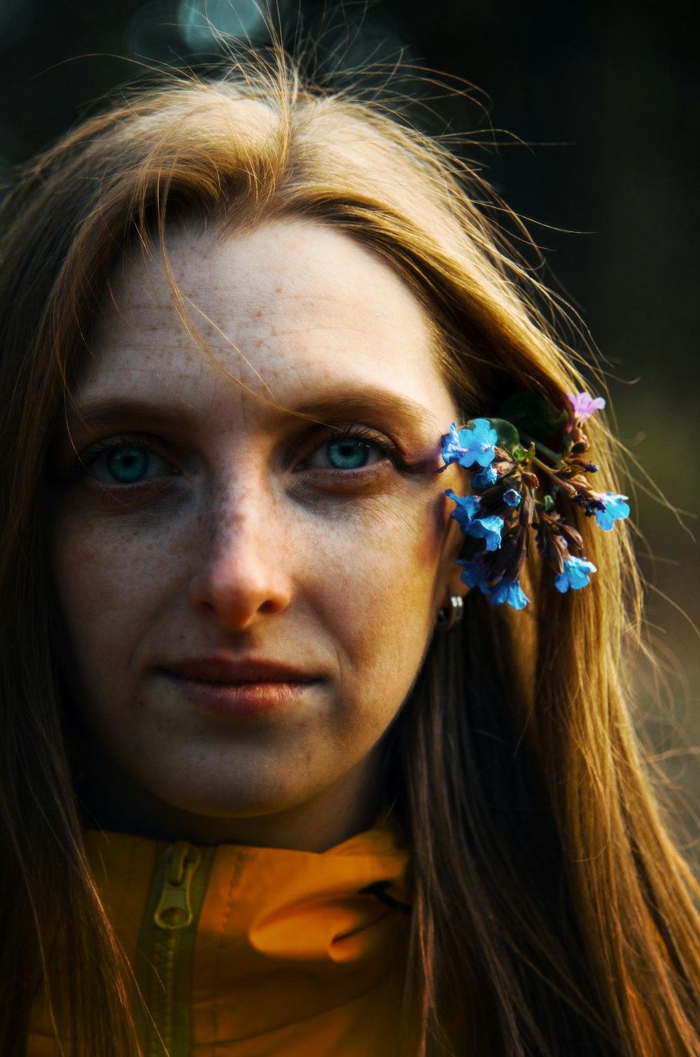 a woman with freckled hair and flowers in her hair