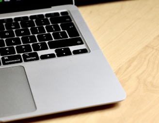 Close-up of hands typing on a notebook keyboard with a sleek design.
