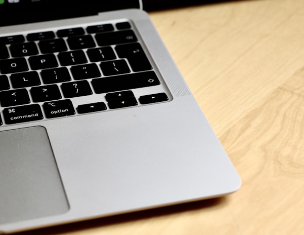 Close-up of hands typing on a notebook keyboard with a sleek design.