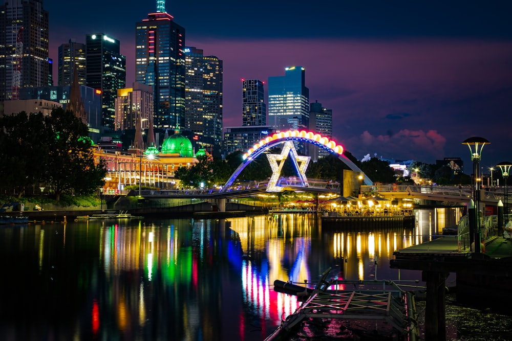 a bridge over a river with a city in the background