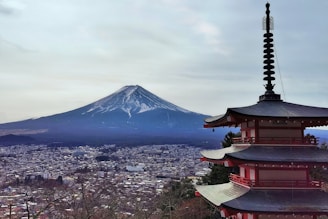a tall pagoda with a mountain in the background
