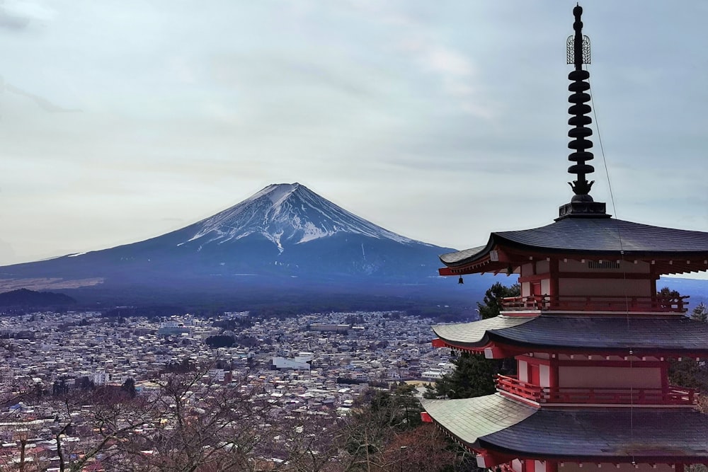 a tall pagoda with a mountain in the background