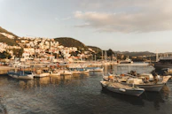 A peaceful seaside town in Spain with boats anchored gently in the harbor under a clear sky.