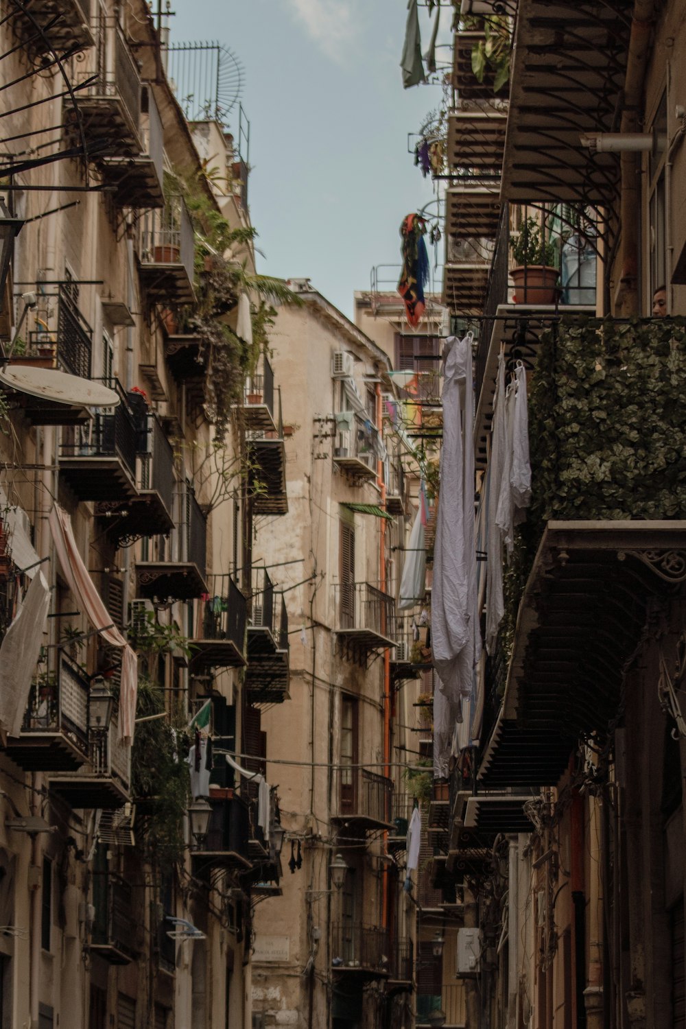 a narrow alleyway with clothes hanging out to dry