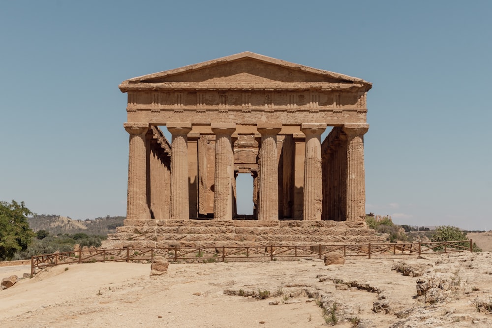 a large stone structure sitting in the middle of a desert