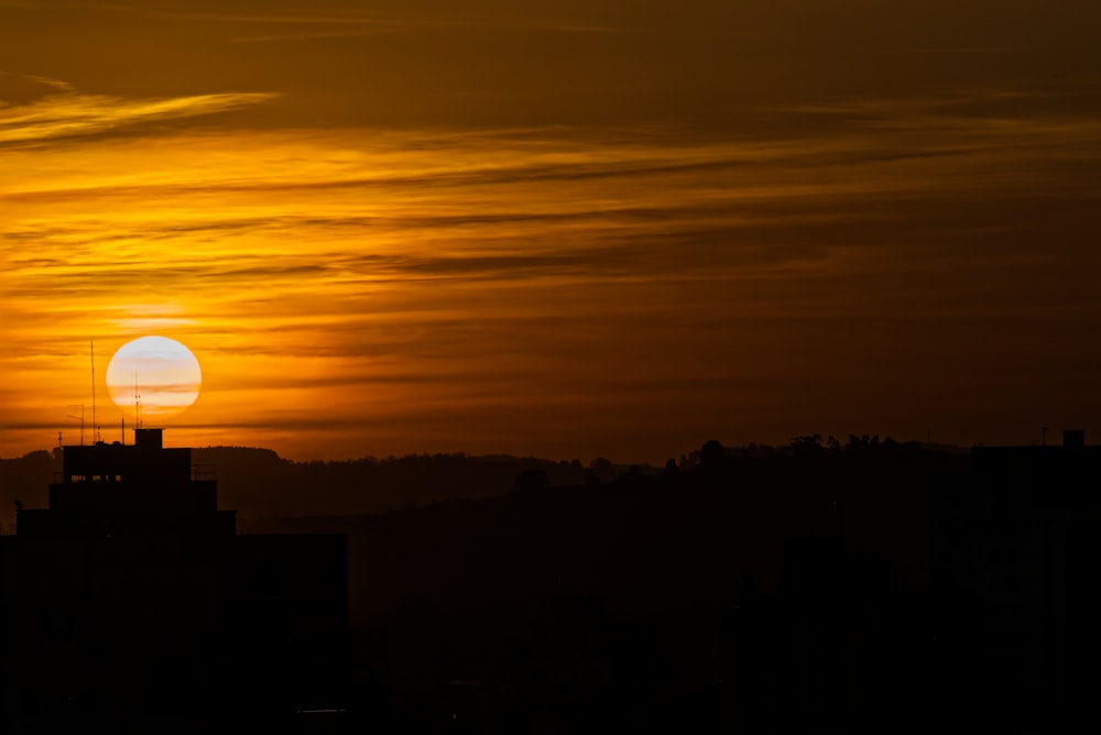 the sun is setting over a city skyline