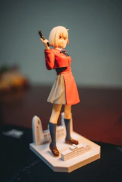 a figurine of a woman holding a gun