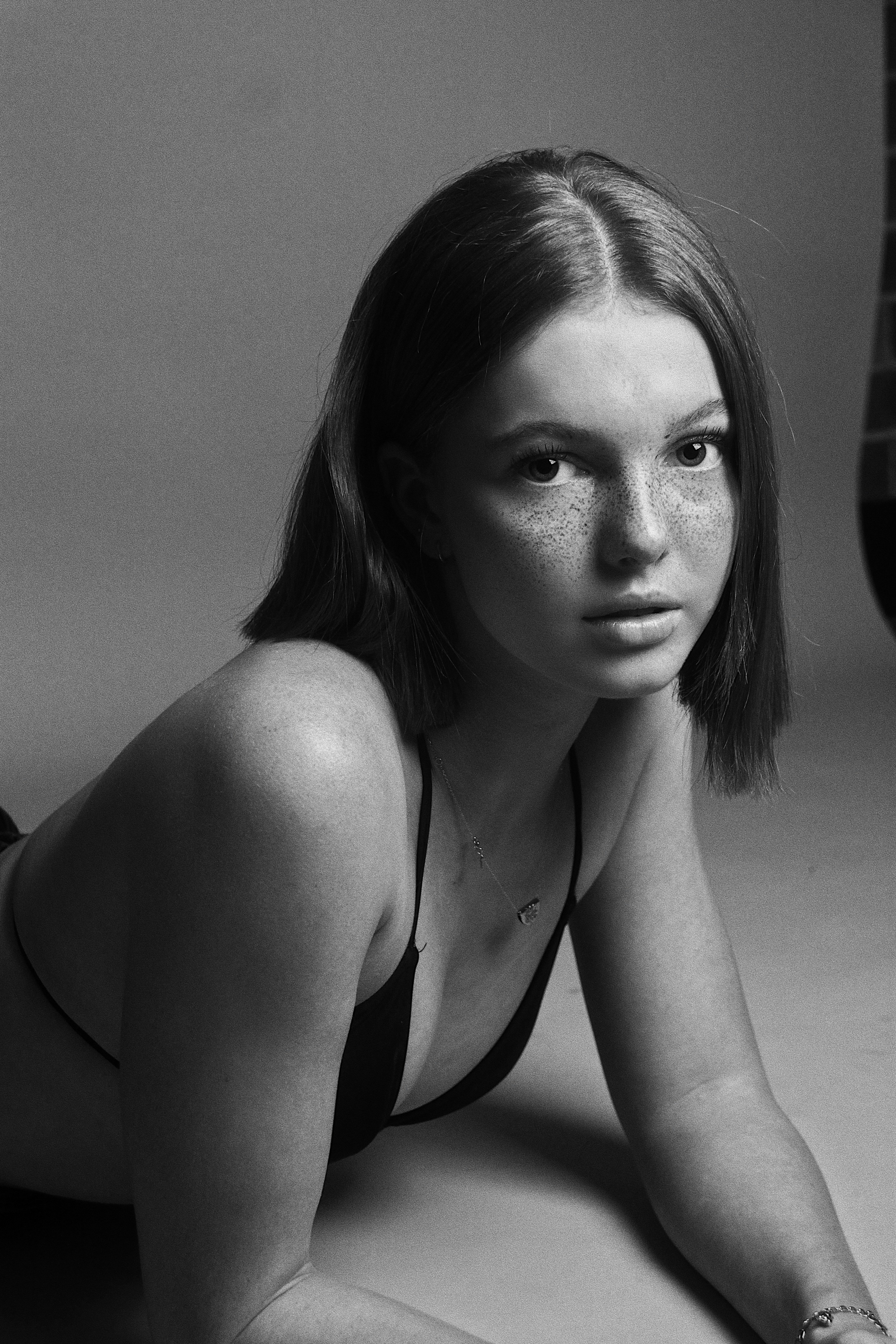 Young woman with freckles lying down