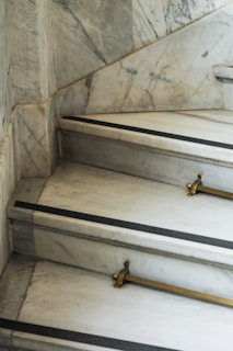 Stylish staircase with hand-painted marble finish and polished wooden steps