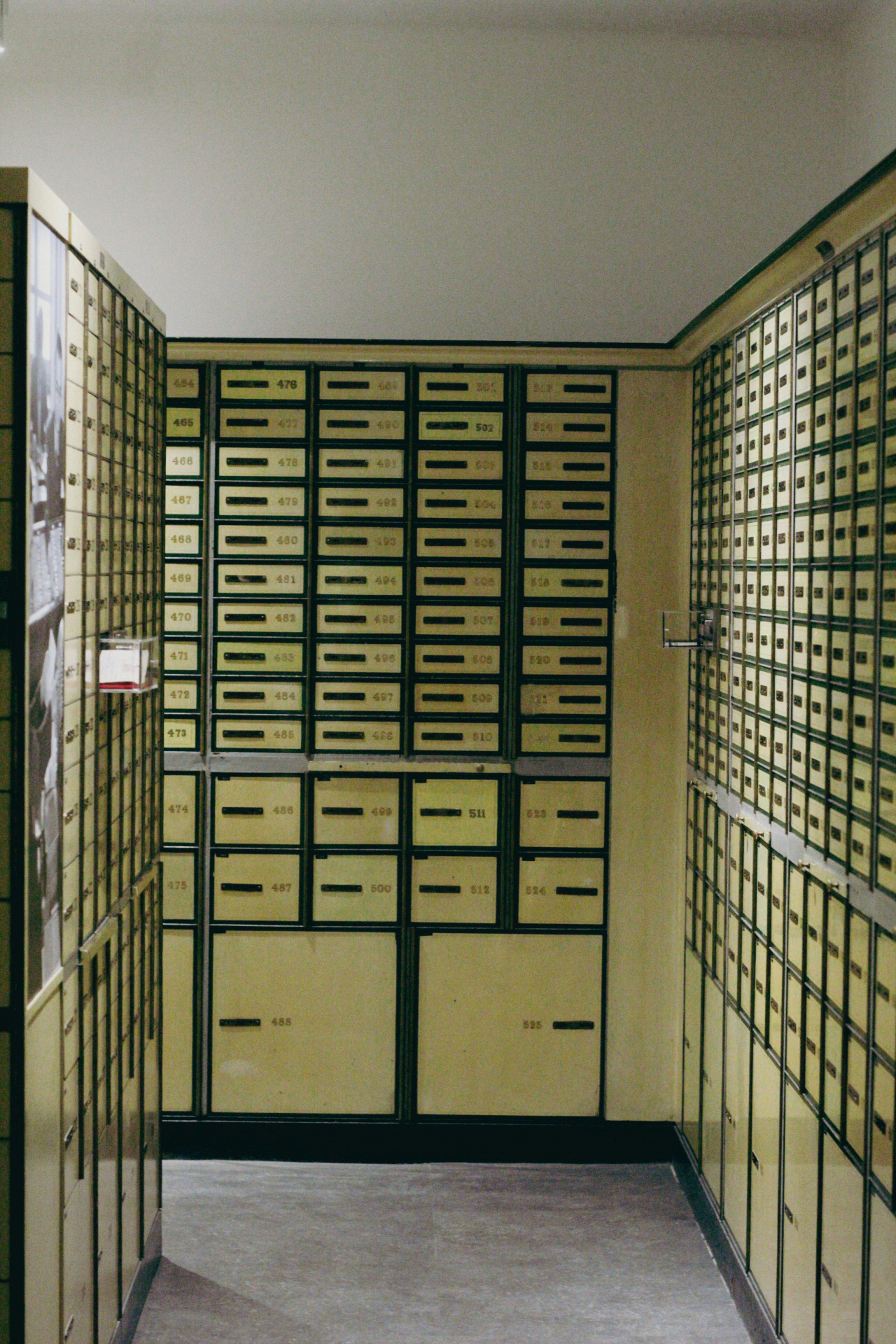 Numbered safety deposit boxes line a secure storage corridor.