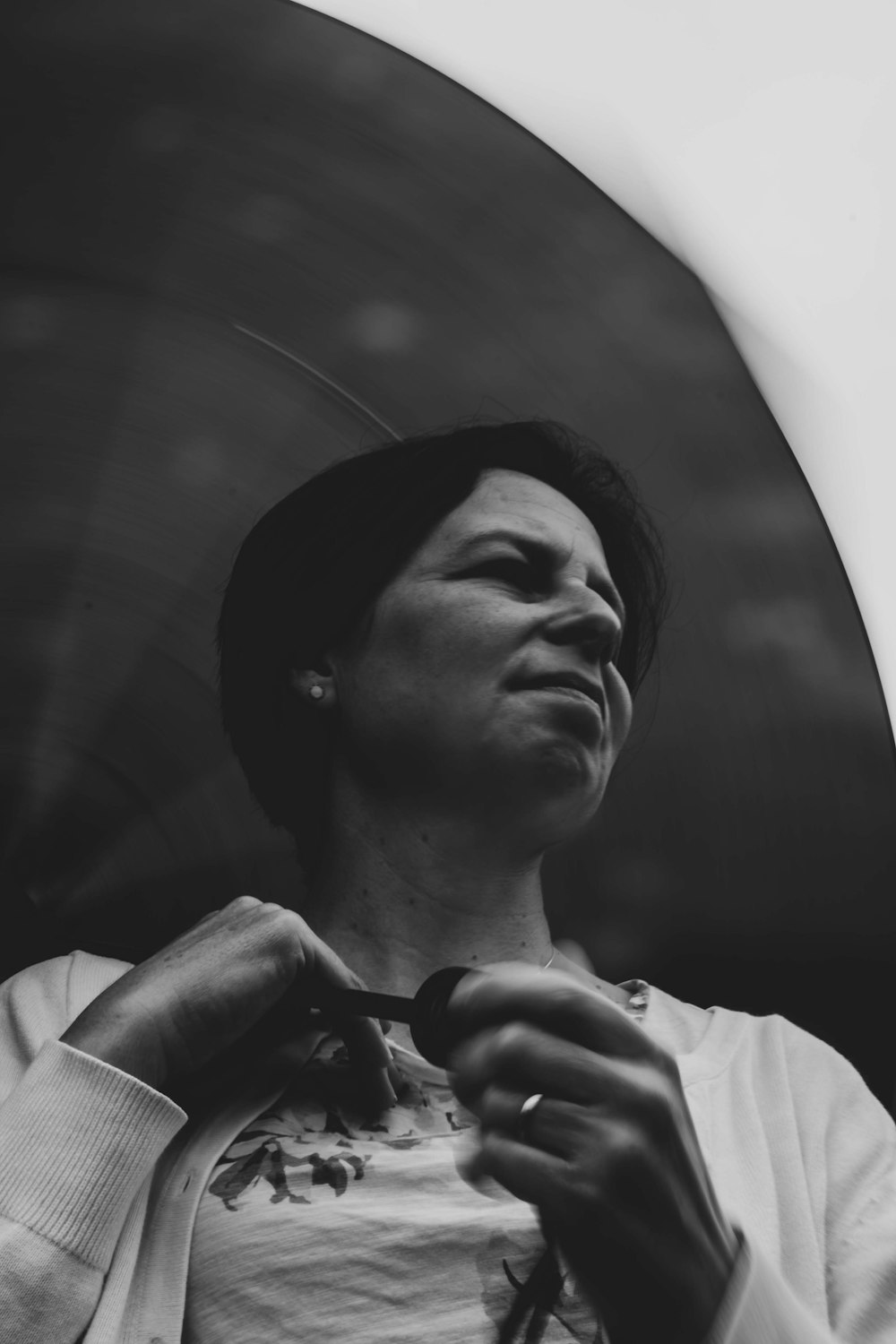 a black and white photo of a woman tying a tie