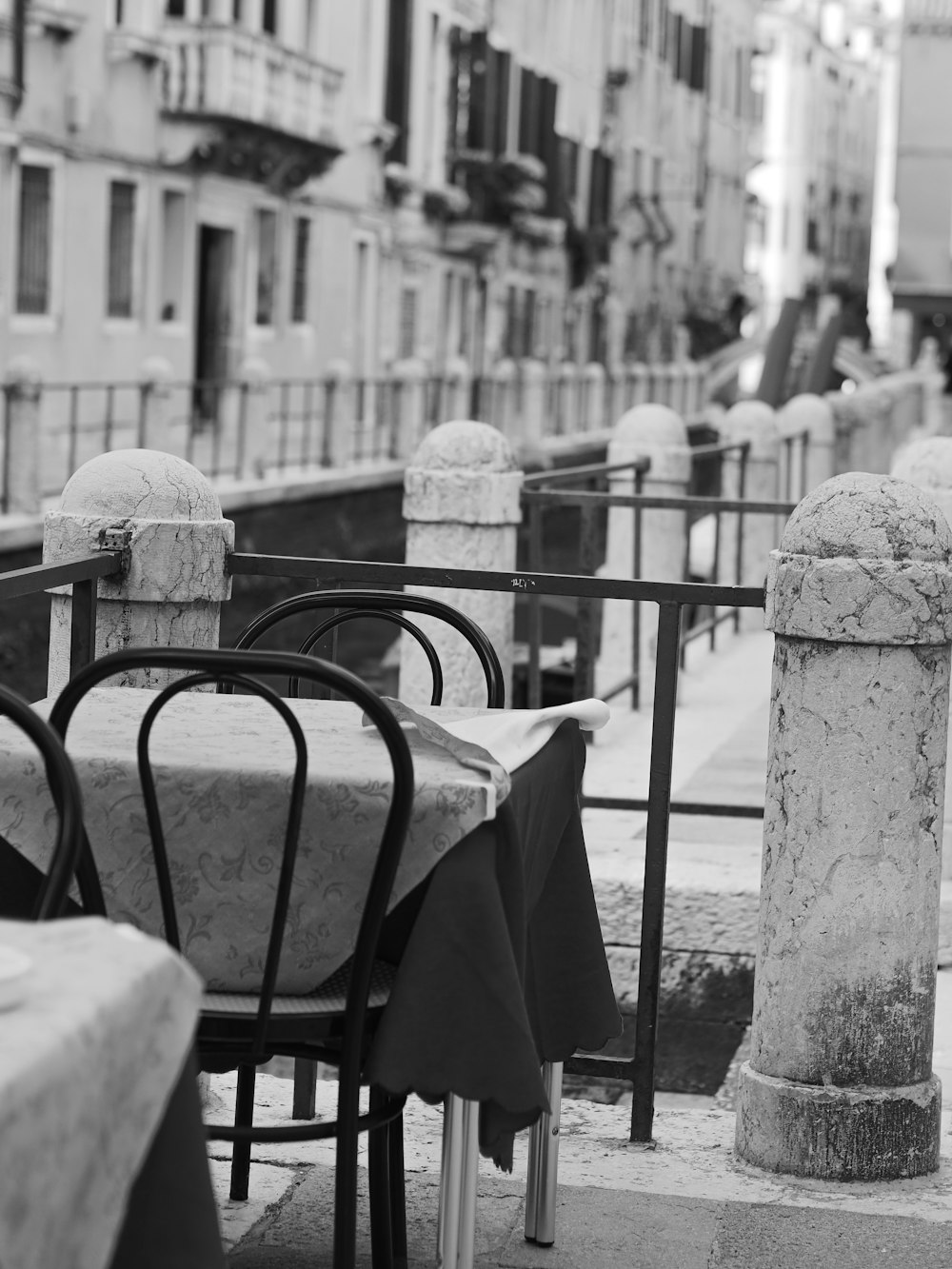 a black and white photo of tables and chairs