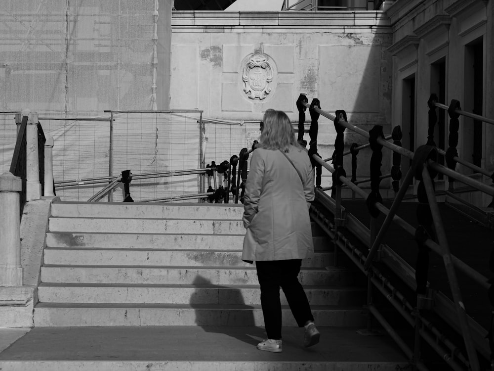 a woman walking up a flight of stairs