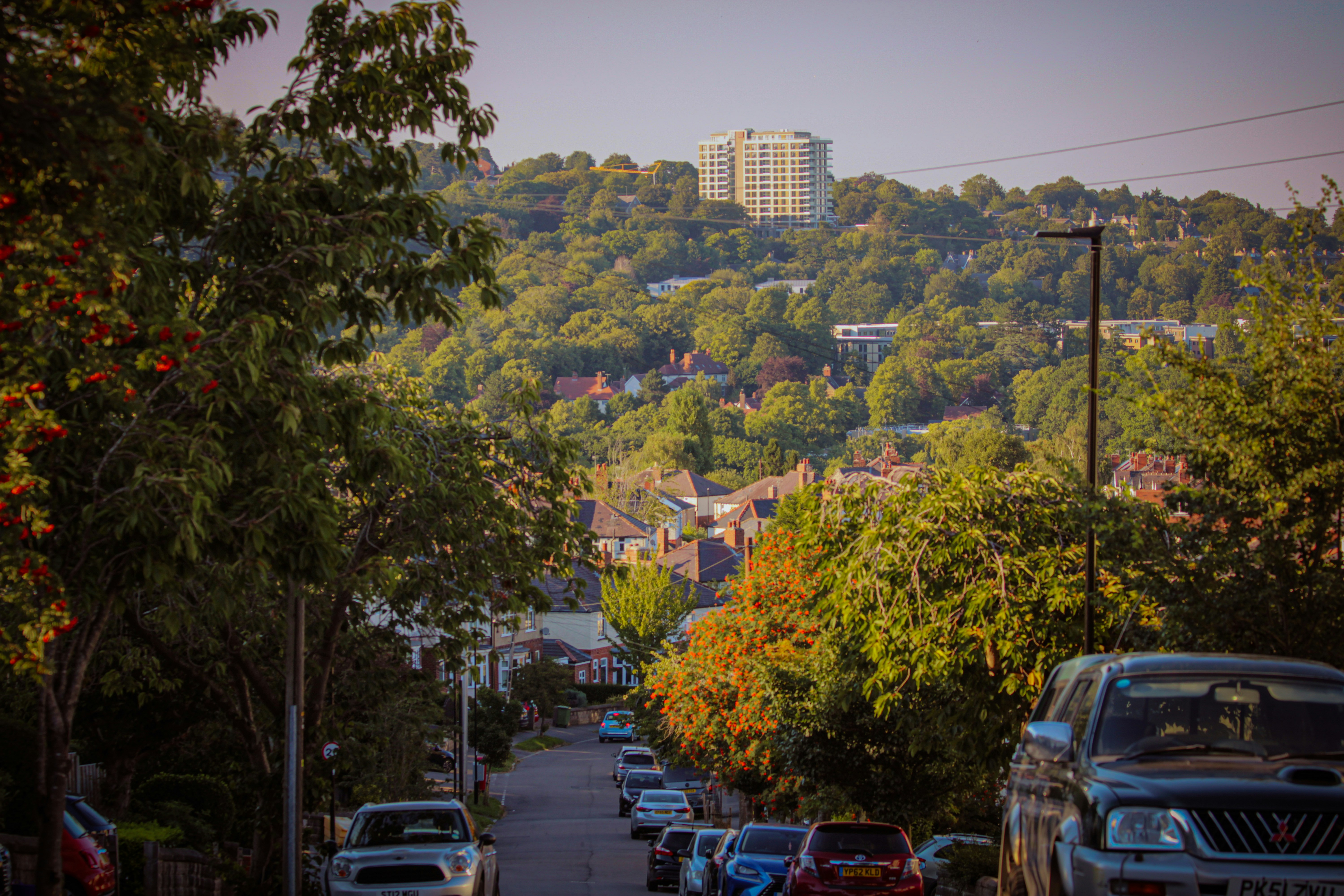 a city street with cars parked on the side of the road