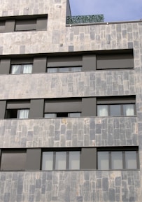 Careful delivery of natural stone slabs to a modern apartment building.