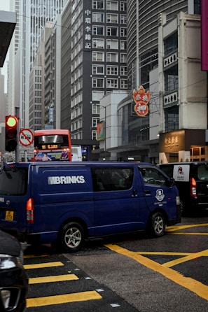 Cash-in-transit armored vehicle driving on an urban street.
