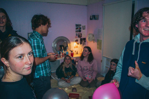 A lively group of young adults sharing product reviews in a cozy, pastel-themed room.