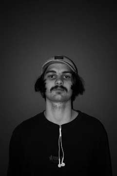 Portrait of DJ lor3nzo_music smiling with headphones around neck