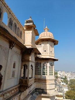 Traditional Indian architectural details of the college building under clear skies.