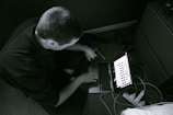 A technician working on a computer in a home setting.