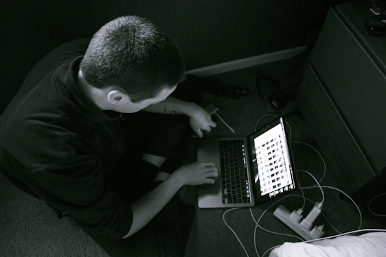 Technician repairing a laptop in a cozy home office setting.