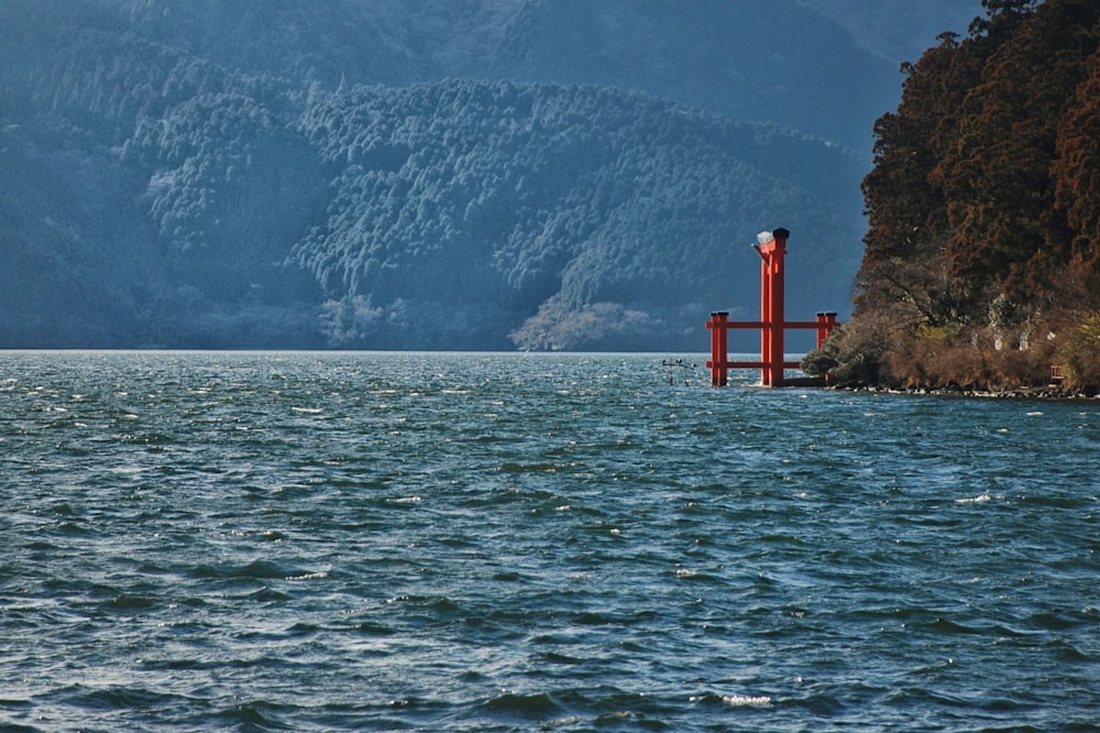 a large body of water with a red structure in the middle of it