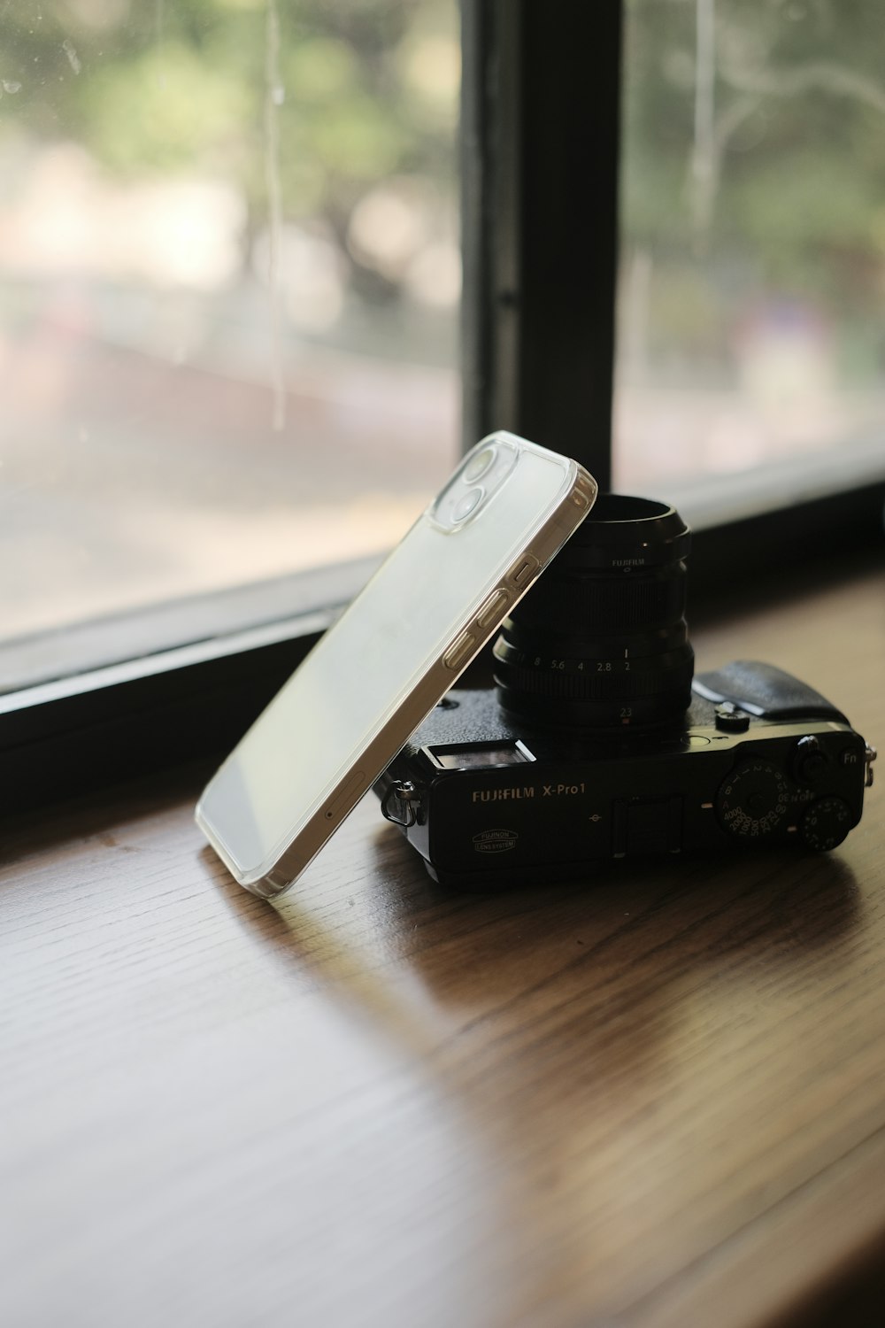 a cell phone sitting on top of a stack of books