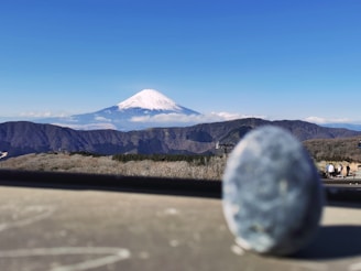 a view of a snow capped mountain from a vehicle