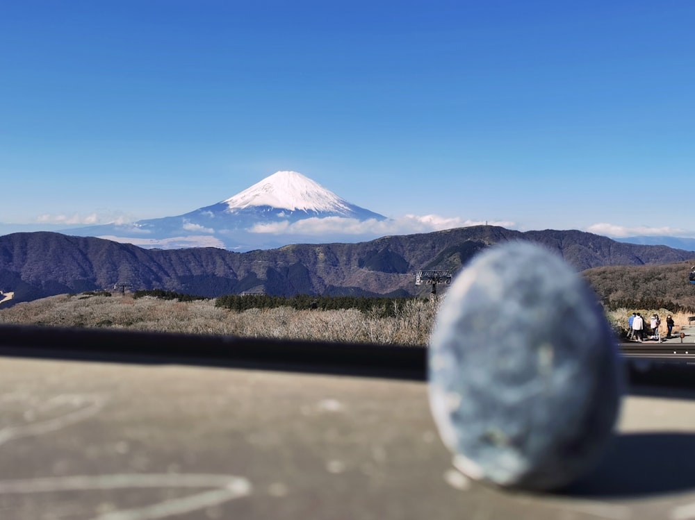 a view of a snow capped mountain from a vehicle