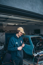 A professional technician installing a garage door with tools.
