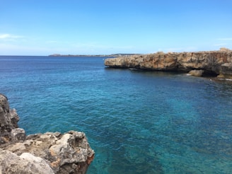 A scenic view of a coastal resort in Montenegro with clear blue waters and sunny skies.