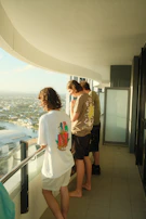 A family enjoying time together on the balcony of a 1 BHK apartment overlooking Nashik city.