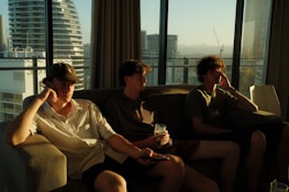 A diverse group of friends enjoying IPTV streaming together on a modern couch.