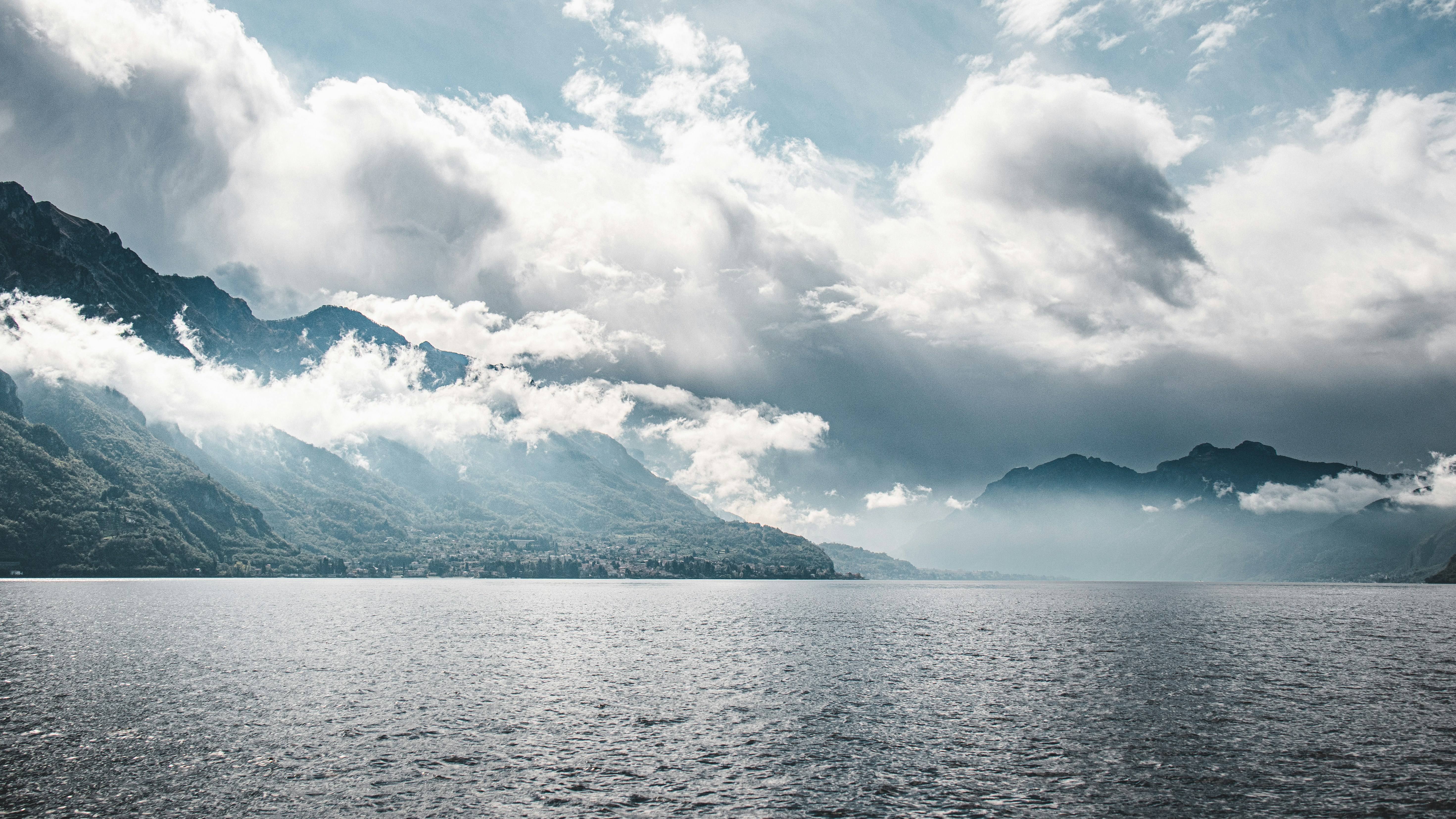 a large body of water surrounded by mountains, 