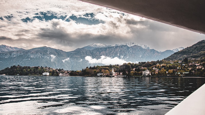 Sailing boat on Lake Como with mountain backdrop, Italy