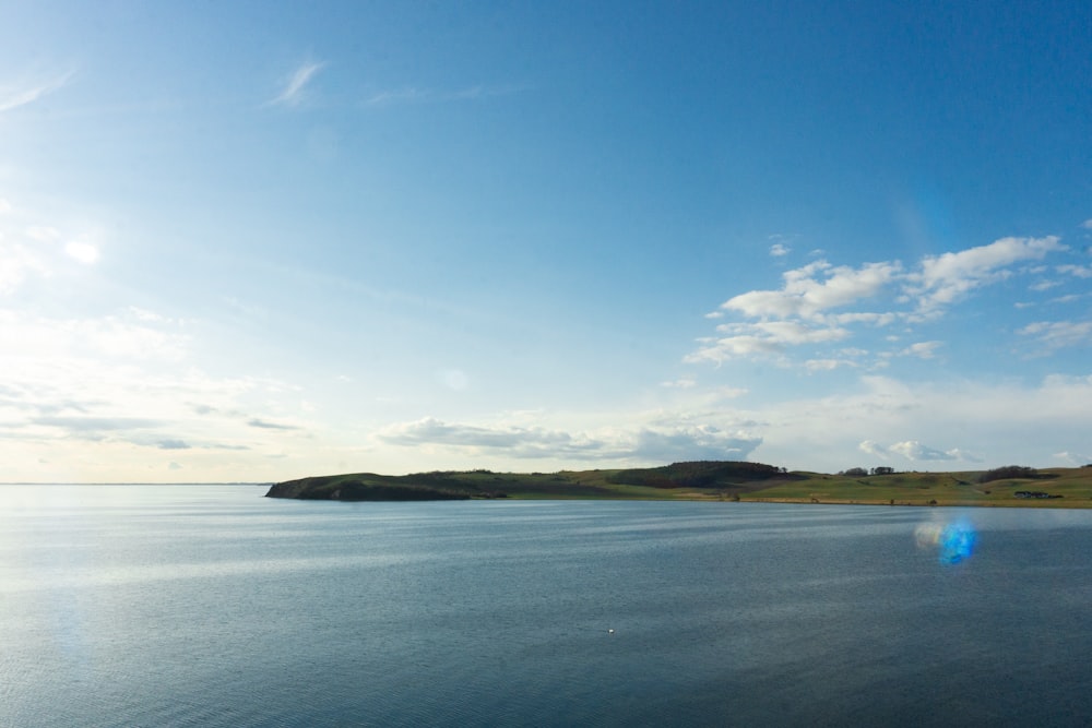 a large body of water with a sky background