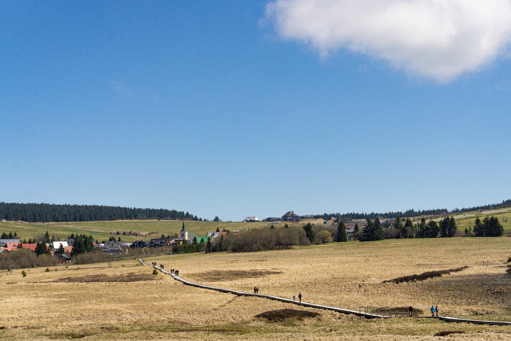 a view of a field with a fence in the foreground