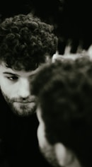 Acting class participant with curly hair checking his cell phone