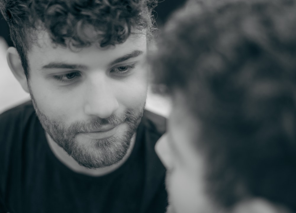 a man looking at his reflection in a mirror