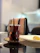 A satisfied customer enjoying a cup of black tea in a cozy café setting.