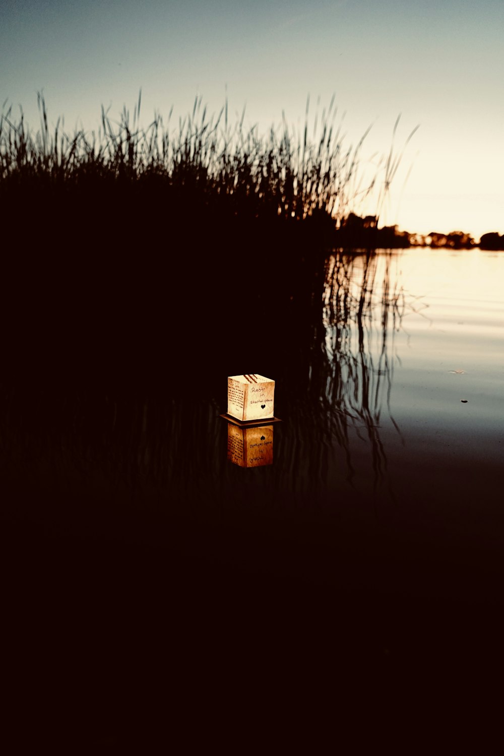 a box sitting in the middle of a body of water
