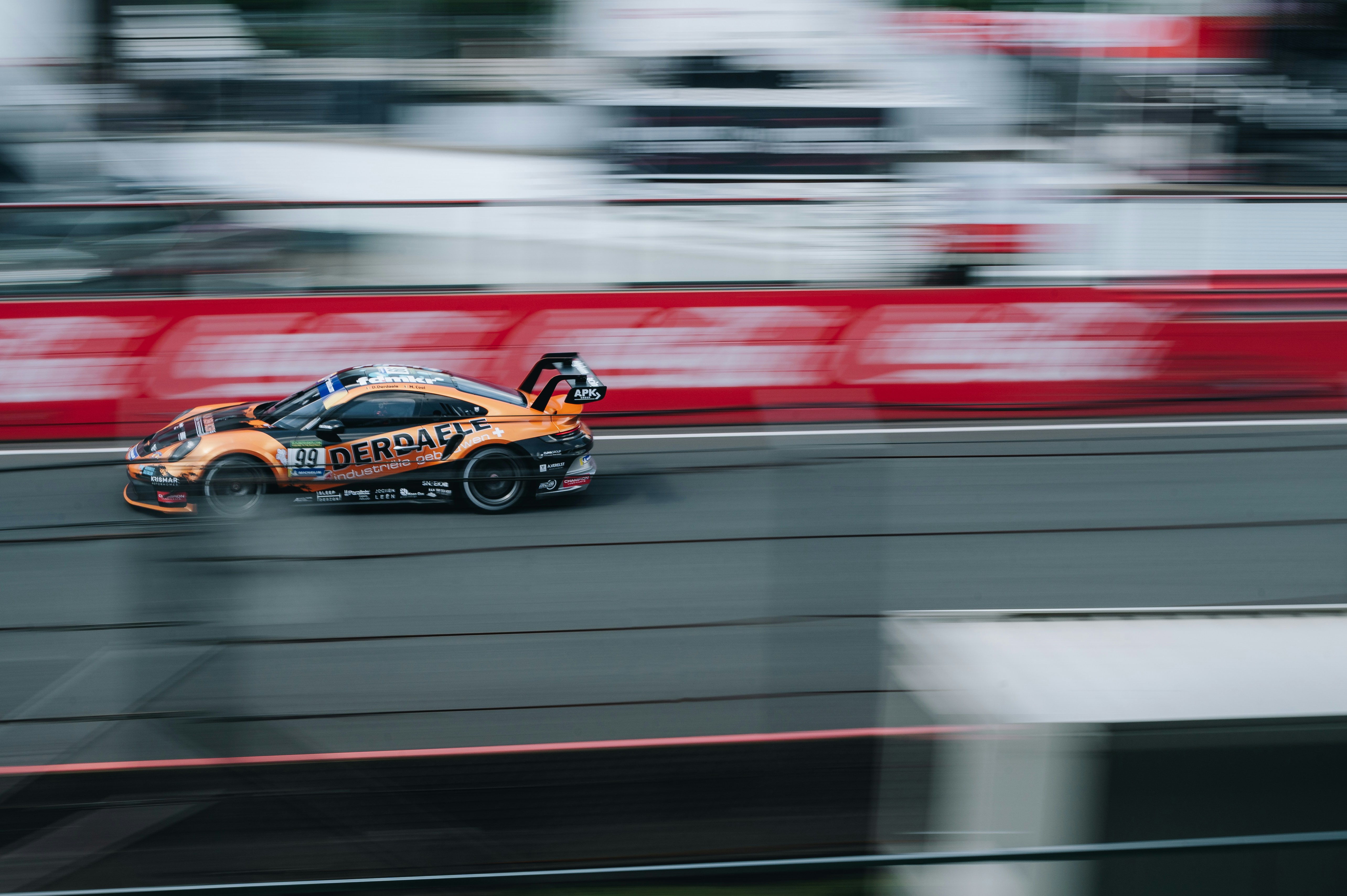 A car driving down a race track in motion photo – Free Car Image on ...