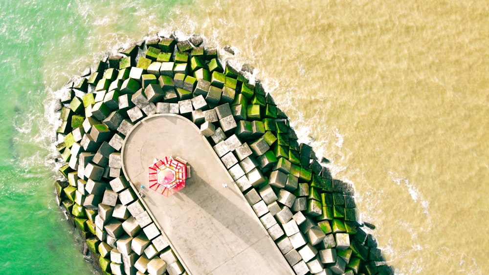 an aerial view of a walkway next to the ocean