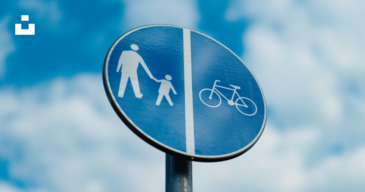 A blue street sign with a picture of a man and a woman holding hands ...